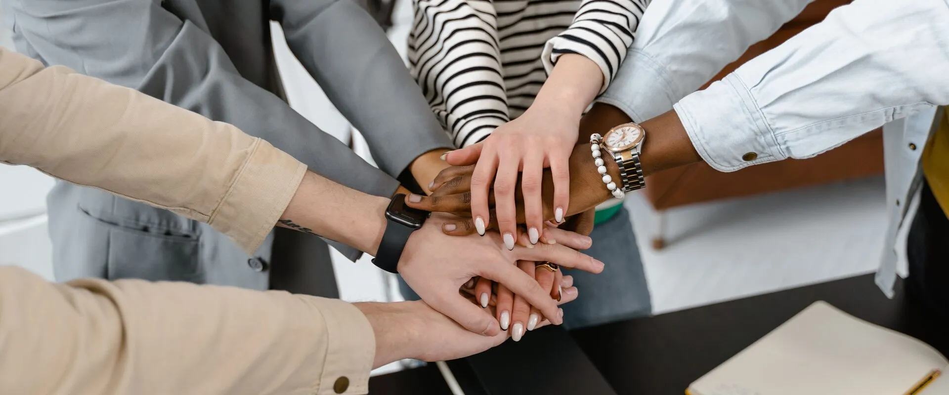 A diverse team joining hands in partnership